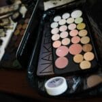 Paleta cieni i zestaw pędzli do makijażu na białym tle